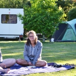 campers-relaxing-on-grass